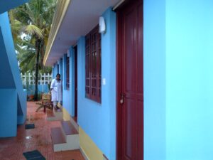 A blue building with red doors.