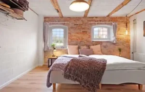 A well lit room with a bed.